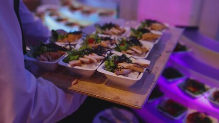 Beautifully decorated banquet catering table, with variety of with different food snacks appetizers on corporate birthday party event or wedding celebration, canape, salad, delicatessen setting