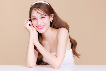 Obraz na płótnie Canvas Pretty Asian beauty woman curly long hair with Korean makeup glowing face and healthy facial skin portrait smile on isolated beige background. Cosmetology ,Plastic surgery.