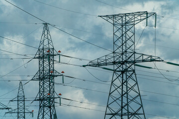 High voltage towers with sky background. Power line support with wires for electricity...