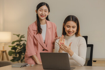 Asian female employees work together at home because they have an important meeting due to the...
