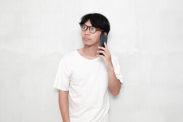 Portrait of young asian man holding smartphone