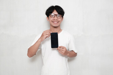 Fototapeta premium Happy man in glasses playing game on white background