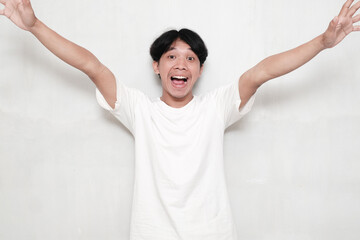 Happy cheerful young man posing isolated on white background