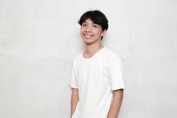 Confident Man. Portrait of smiling Asian man wearing blank white t-shirt for design print mockup,...