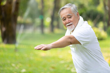 asian senior man workout and static stretching in the park