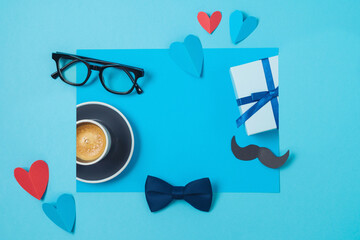 Happy Fathers day creative concept with coffee cup,  heart shape and gift box on blue background....