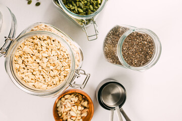 Oatmeal, chia and pumpkin seeds in a glass jars, ingredients for granola or overnight oats