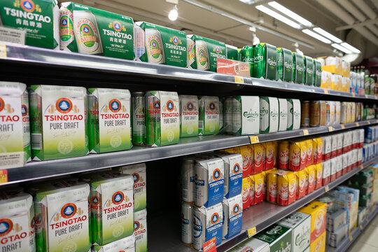 HONG KONG, CHINA - DECEMBER 06, 2023: Tsingtao beer cans for sale at Wellcome supermarket in Hong Kong.