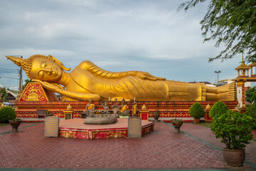 The gold-reclining Buddha statue at Wat That Luang Tai, Vientiane, Laos