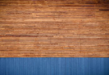 blue metal siding and wooden boards on the facade as a background