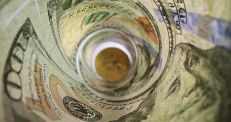 100 dollar bills with gold bitcoin in center - Powered by Adobe