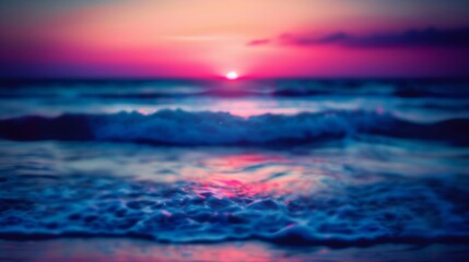Blurry image of ocean waves under a sunset sky, with vibrant colors.