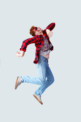 Scary zombie man jumping on grey background