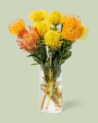 Yellow pincushions in glass vase, flower arrangement, home decor