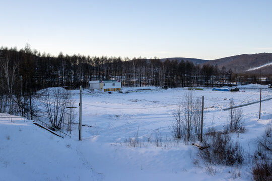Tynda, Amur region, Russia - January 23, 2024. View of the snow-covered stadium. Reconstruction of the BAM stadium in the city of Tynda. In 2022, during the flood, the stadium was completely flooded.