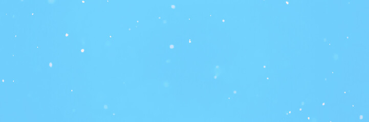 Wide panoramic winter background. Blue sky with falling snow, snowflake.