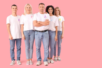 Obraz premium Diverse group of people wearing awareness ribbons for support and solidarity on pink background