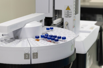 	 Automated laboratory sample handling system with vials in gas chromatography autosampler carousel. Modern scientific research and pharmaceutical testing equipment for chemical analysis