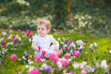 Child in spring park with flowers