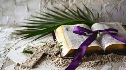 Ash Wednesday concept. Cross and a purple ribbon on top of an open bible covered with ashes. 