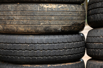 Old tires stacked in a heap, forming a textured pattern