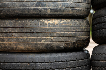 Stacked old tires create a towering pile, evoking a sense of abandonment and neglect