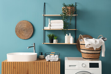 Interior of laundry room with sink and basket on washing machine