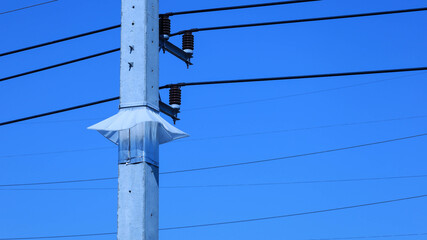 Guard against snakes on high voltage poles. Closeup of pole guards made of plastic and aluminum...