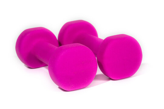 A pair of pink dumbbells for sports and fitness at the gym. Isolated in white bacground.