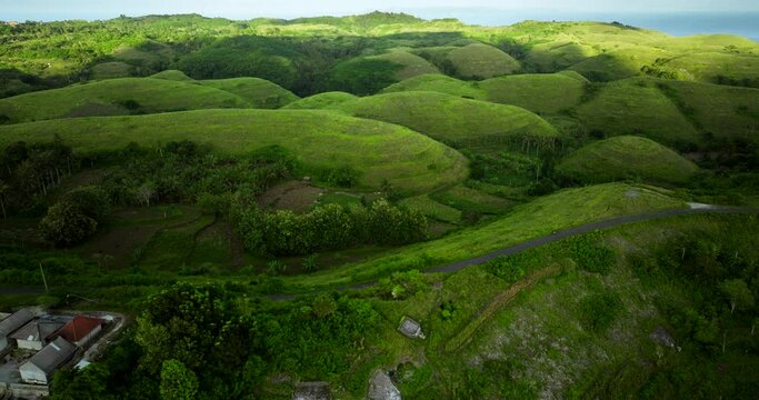 Like little mouse, girl on scooter driving amongst lush green teletubbies