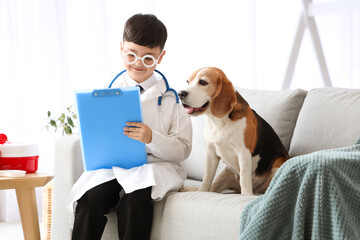 Cute little doctor with clipboard and Beagle dog at home