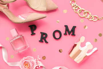 Word PROM with crown perfume bottle and female shoes on pink background