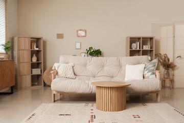 Interior of cozy living room with couch, table and shelf units