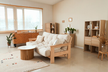 Interior of cozy living room with couch, table and shelf units