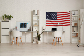 Interior of medical office with tables and USA flags