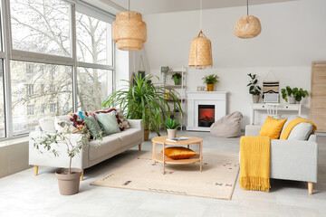 Obraz premium Interior of stylish living room with sofas, houseplants and coffee table