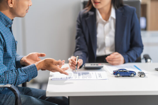 Asian businesswoman specializing in car loan services. Proficient in terms like extended warranty, lease, MSRP, and navigating financing options for customers' automotive needs.