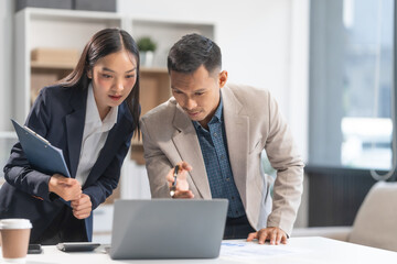 Collaboration between young Asian businesswoman and middle-aged businessman, achieving business success through dedication, effective efforts, and triumphant breakthroughs, milestones in careers.