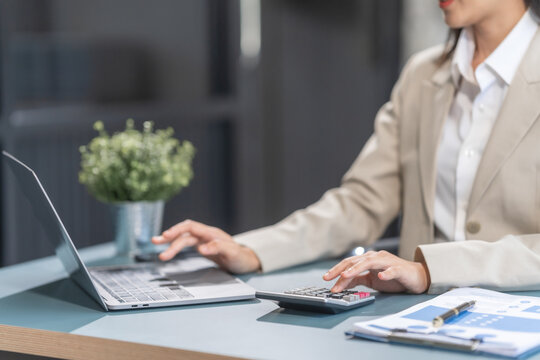 Proficient Asian businesswoman specializing in credit management. Skilled in navigating credit bureaus, analyzing APRs, managing balances, and optimizing credit card usage for financial goals.