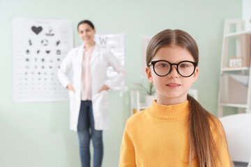 Little girl with eyeglasses in clinic, closeup