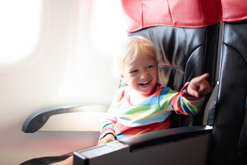 Child flying in airplane. Flight with kids.