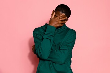 Man facepalm, shy person on pink background