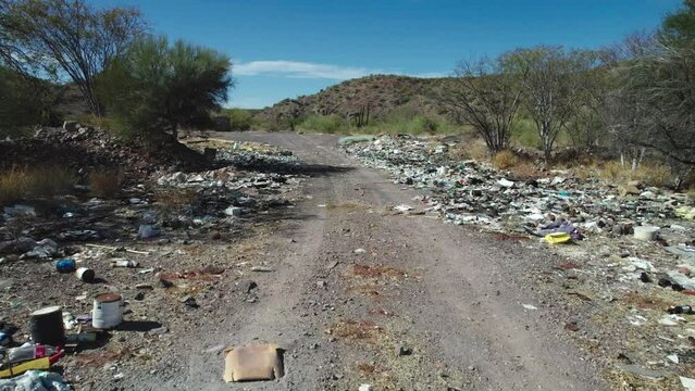 Garbage Along the Roadside Detracting From the Desert Landscape of Mulege, Baja California Sur, Mexico - Drone Flying Forward