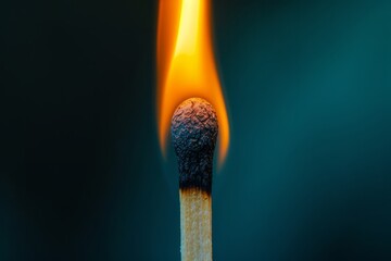 Illuminated matchstick with a dynamic flame against a dark background. Perfect for concepts about ideas and ignition.