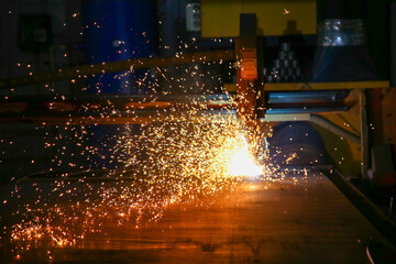 sparks flying while machine griding and finishing metal plasma cutting