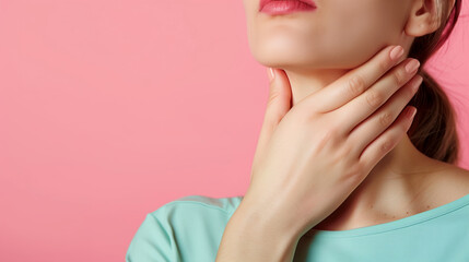 Woman's hands touch her neck. Concept of thyroid disease or sore throat.