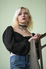 Studio portrait of a young beautiful blonde long-haired girl.