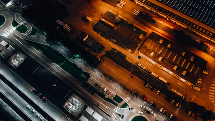 Top view of the bus station and road traffic at night. Car parking top down view