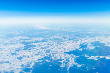 Beautiful view from the airplane porthole. blue sky, clouds, earth.