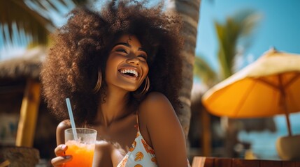 African American woman drinking a summer cocktail on the beach